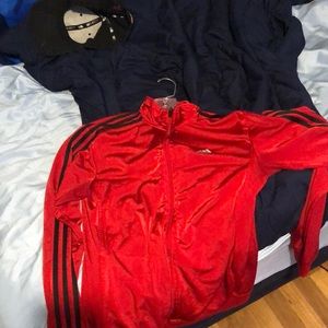 This is an adult small adidas jacket red with black stripes.